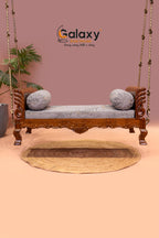 Wooden swing with cushion and carved peacock khat design